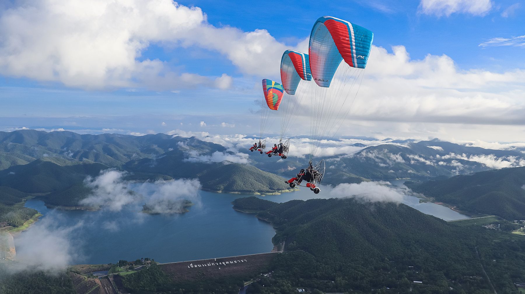 Adventure activities in Chiang Mai including paramotor flying over mountains
